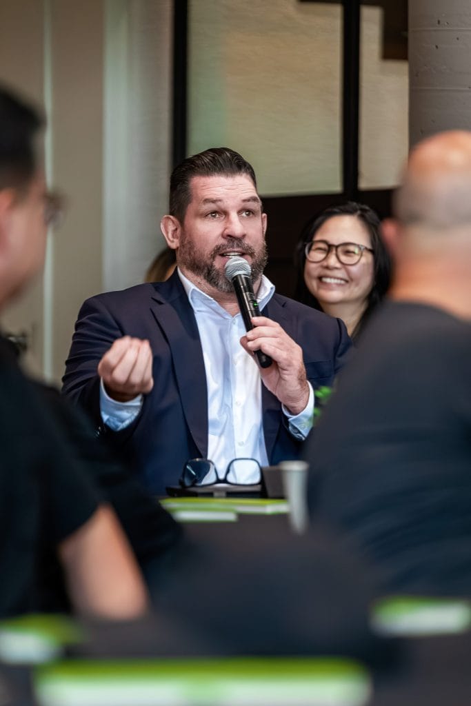 corporate event photography in laval a man speaking at event